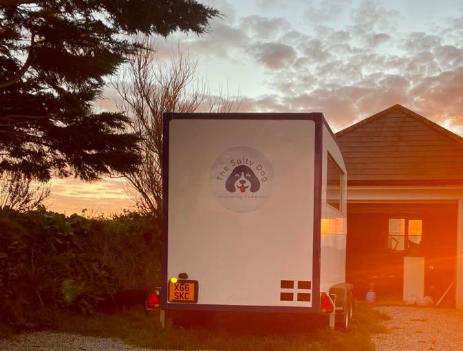 The sun setting over my grooming trailer (with handsome chap Kendi!)