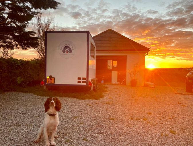 The sun setting over my grooming trailer (with handsome chap Kendi!)